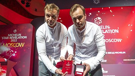 Twins, Garden chefs Ivan and Sergey Berezutsky, who received two Michelin stars, show their award as they take part in the award ceremony, which took place in Moscow.
