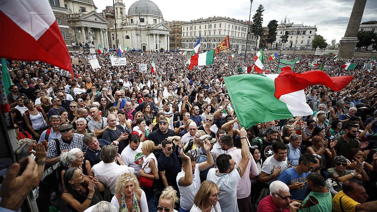 People gather in Piazza del Popolo square during a protest, in Rome, Saturday, Oct. 9, 2021.