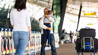 Families reuniting at an airport.