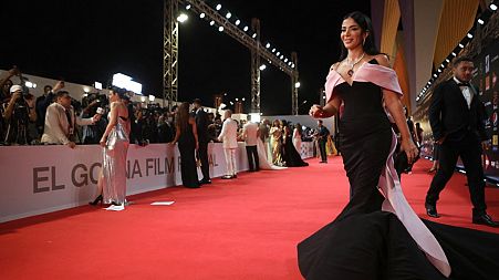 Egyptian actress Mona Zaki walks the red carpet during the 5th edition of the Gouna Film Festival, in Egypt's Red Sea resort of el-Gouna on October 14, 2021.