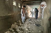 People inspect the inside of a mosque following a suicide bombers attack in the city of Kandahar, southwest Afghanistan, Friday, Oct. 15, 2021.
