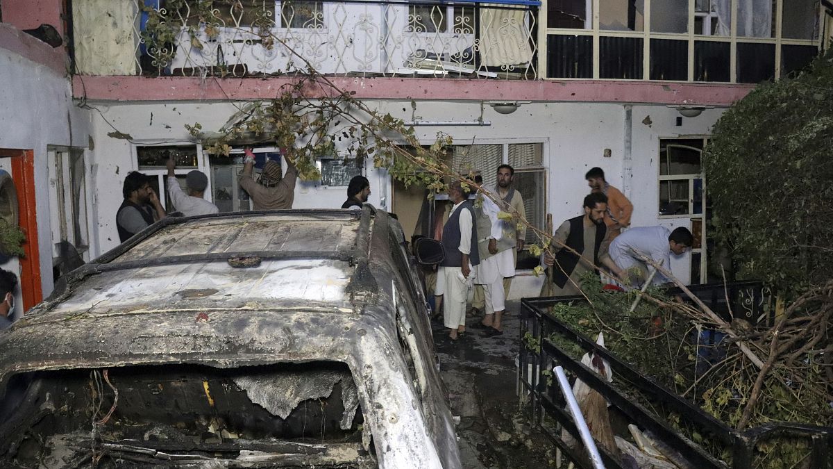 FILE - In this Sunday, Aug. 29, 2021 file photo, Afghans inspect damage of Ahmadi family house after U.S. drone strike in Kabul, Afghanistan.
