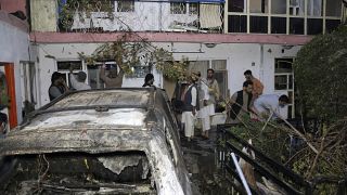 FILE - In this Sunday, Aug. 29, 2021 file photo, Afghans inspect damage of Ahmadi family house after U.S. drone strike in Kabul, Afghanistan.