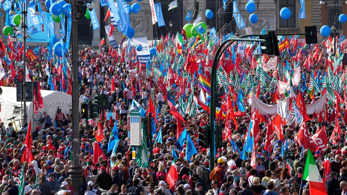 Demonstrators take part in a march organized by Italy's main labour unions, in Rome's St. John Lateran square, Saturday, Oct. 16, 2021