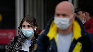 People wearing face masks to help curb the spread of the coronavirus leave a subway in Moscow, Russia, Friday, Oct. 15, 2021.