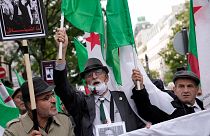 Demonstrators holding Algerian flags chant slogans in Paris, Sunday, Oct. 17, 2021.