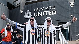 Newcastle fans pose for a photo outside the ground before an English Premier League match between Newcastle and Tottenham Hotspur at St. James' Park in Newcastle.