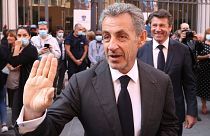 French former President Nicolas Sarkozy waves as he leaves after a tribute ceremony for Samuel Paty in Nice, 15 October 2021