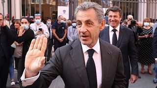 French former President Nicolas Sarkozy waves as he leaves after a tribute ceremony for Samuel Paty in Nice, 15 October 2021