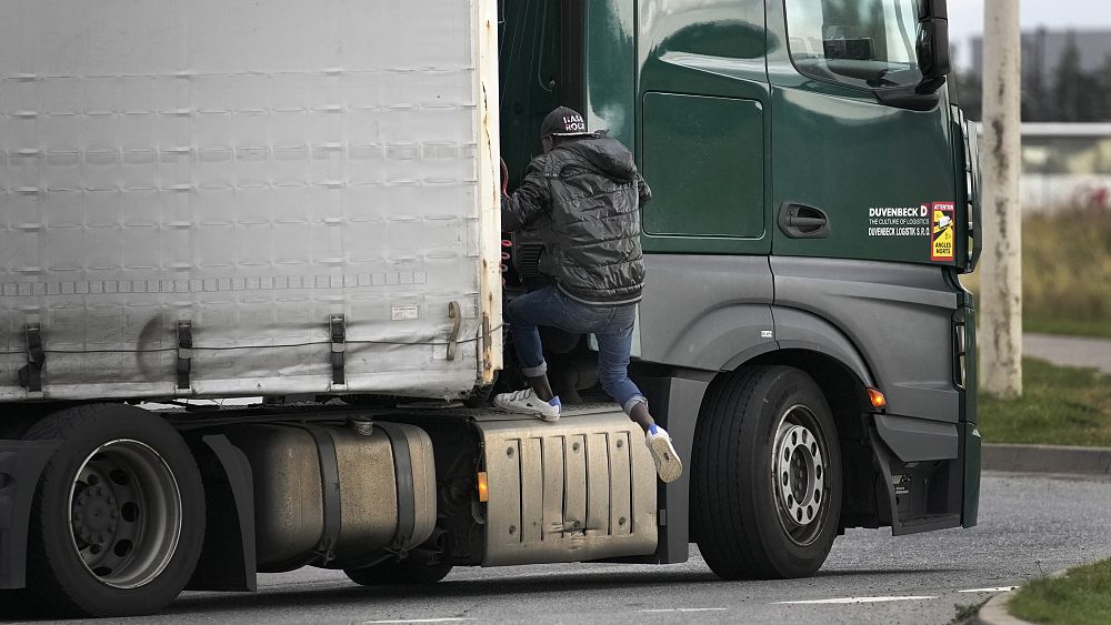 Watch: Migrants cling to UK-bound trucks in dangerous attempt to cross the English Channel