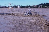 A statue of Hindu god Lord Shiva is pictured amid the risen water levels of River Ganga