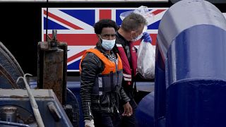 A man thought to be a migrant who made the crossing from France is disembarked after being picked up in the Channel by a British border force vessel in Dover