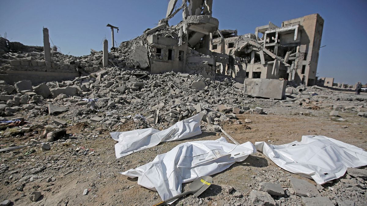 Bodies covered following a 2019 bombing during the conflict in Yemen
