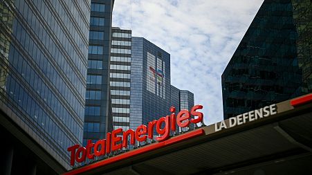 This photograph taken on May 28, 2021 shows the new TotalEnergies logo during its unveling ceremony, at a charging station in La Defense on the outskirts of Paris.