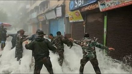 Building collapse and rescue operations after deadly floods.