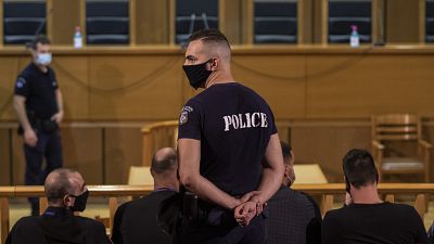 A police officer stands in a court in Athens on Oct. 7, 2020.