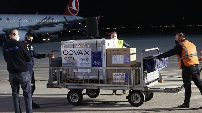 Airport personal unload the first batch of the AstraZeneca vaccines sent from the Covax facility, at Adem Jashari airport Pristina, Kosovo, March 28, 2021.