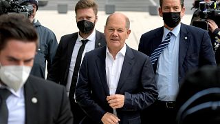Olaf Scholz, center, of the German Social Democratic party (SPD) arrives for coalition negotiations in Berlin, Germany, Oct. 21, 2021.