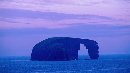 Looking Over To The Small Island Of Dore Holm With The Sea Weathered Natural Arch Visible, Off The West Coast Of Mainland, South East Of Stenness, Shetland