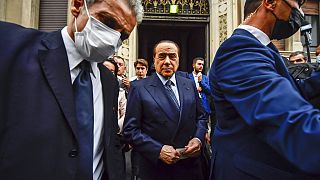 FILE - In this Sunday, Oct. 3, 2021 file photo, Silvio Berlusconi leaves a polling station in Milan, Italy.