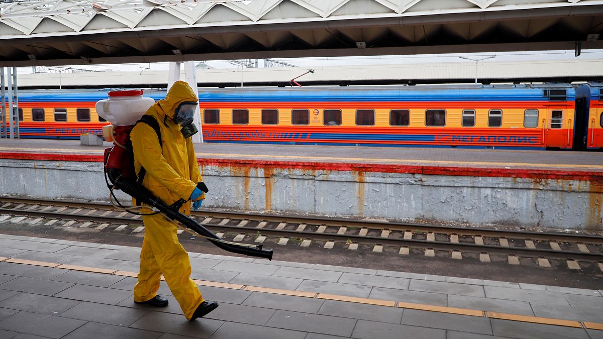 An emergency worker disinfects Leningradsky railway station in Moscow