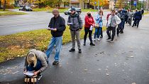 People stand in line to get a jab in a Covid-19 vaccination bus is seen in Riga, Latvia