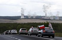 Cars drive slowly to block a border between Czech Republic and Poland near the Turow mine near Bogatynia, Poland, Tuesday, May 25, 2021