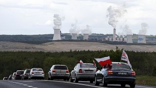 Cars drive slowly to block a border between Czech Republic and Poland near the Turow mine near Bogatynia, Poland, Tuesday, May 25, 2021