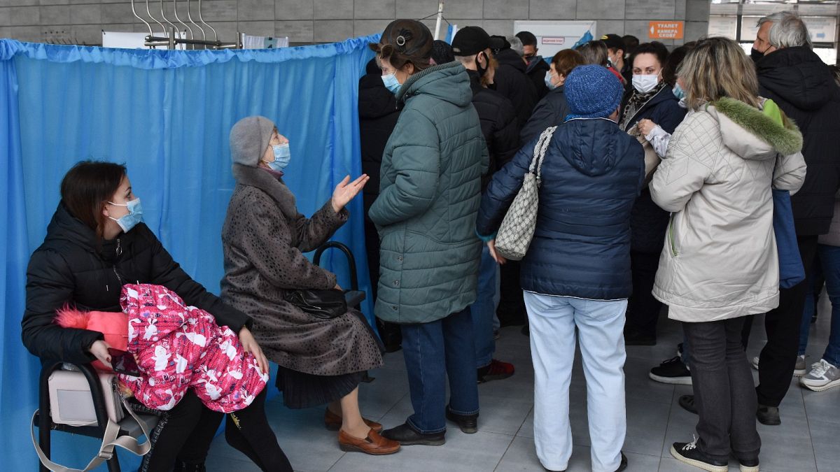 People wait for their turn at a vaccination center in Kramatorsk, Ukraine, Friday, Oct. 22, 2021.