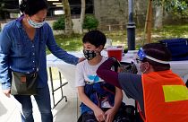 Colin Sweeney, 12, gets a shot of the Pfizer COVID-19 vaccine in California.