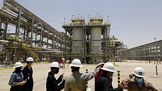 In this June 28, 2021, file photo, Saudi Aramco engineers and journalists look at the Hawiyah Natural Gas Liquids Recovery Plant in Hawiyah, in Saudi Arabia.