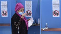 A woman walks to cast her ballot at a polling station during the presidential election in Tashkent, Uzbekistan, Sunday, Oct. 24, 2021.