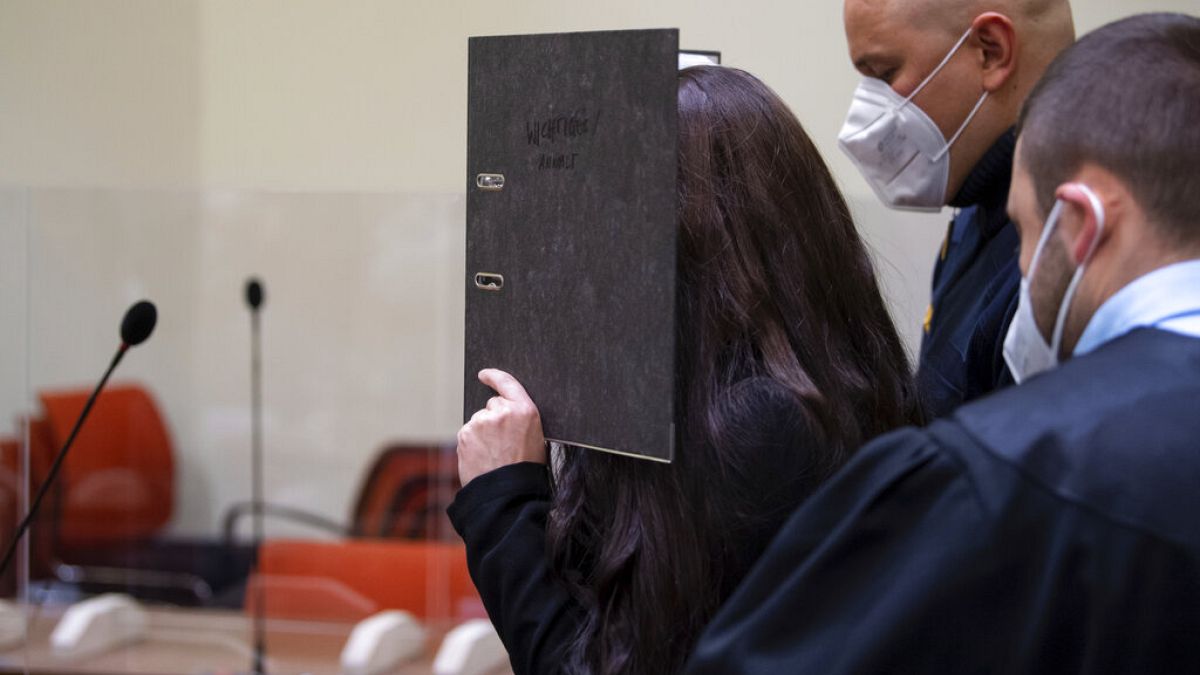 Defendant Jennifer W. arrives in a courtroom for her trial in Munich, Germany, Monday, Oct. 25, 2021. 