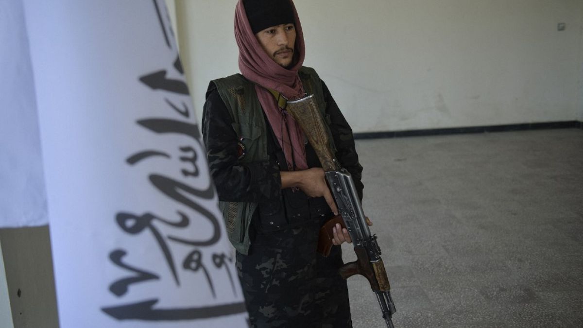 A Taliban fighter stands guard at the venue of a launch ceremony of a programme by Afghanistan's Taliban government to tackle hunger on October 24, 2021.