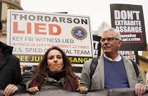 Julian Assange's partner Stella Morris, left, and Wikileaks editor-in-chief Kristin Hrafnsson hold placards and take part in a march in London, Saturday, Oct. 23, 2021