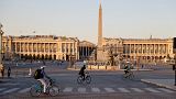 People ride bikes on the deserted Place de la Concorde, during the curfew, aimed at curbing the spread of the Covid-19 disease, in Paris, on March 30, 2021.