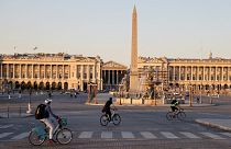 People ride bikes on the deserted Place de la Concorde, during the curfew, aimed at curbing the spread of the Covid-19 disease, in Paris, on March 30, 2021.
