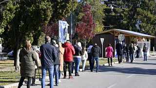 People stand in line to test for COVID-19 in Michalovce, Slovakia, Monday, Oct. 25, 2021.