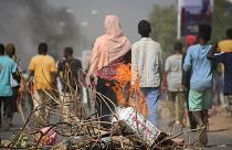 Pro-democracy protesters use fires to block streets to condemn a takeover by military officials in Khartoum, Sudan, Monday Oct. 25, 2021. 