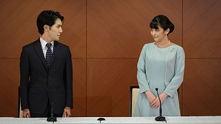Japan's former Princess Mako and her husband Kei Komuro pose during a press conference to announce their marriage, at a hotel in Tokyo, Japan, Tuesday, Oct. 26, 2021