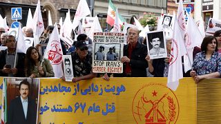 Supporters of the People's Mojahedin Organization of Iran protest outside Stockholm's district court on the first day of the trial of Hamid Nouri on Aug. 10, 2021.