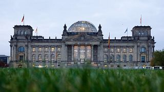 The building of German parliament, the Reichstag, is illuminated in Berlin, Tuesday, Oct. 26, 2021.