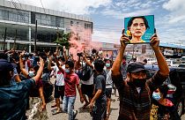 A protester holds up a picture of Myanmar's detained civilian leader Aung San Suu Kyi to mark her birthday during a protest against the military coup, Yangon, June 19, 202`1.