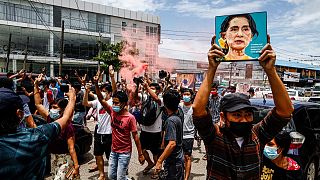 A protester holds up a picture of Myanmar's detained civilian leader Aung San Suu Kyi to mark her birthday during a protest against the military coup, Yangon, June 19, 202`1.