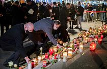 Candles are laid during a memorial service on the 4th anniversary of the attack on the Christmas market at Breitscheidplatz, in Berlin, Germany, Saturday, Dec. 19, 2020