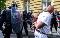 A man asks a police officer to handcuff him during a rally honouring Stanislav Tomas.