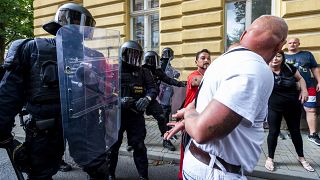 A man asks a police officer to handcuff him during a rally honouring Stanislav Tomas.