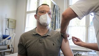 German Health Minister Jens Spahn is vaccinated against influenza in a doctor's office in Berlin, Germany, Wednesday, Oct. 6, 2021.