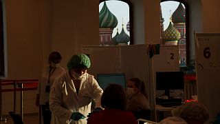 A medical worker administers a shot of Russia's Sputnik Lite coronavirus vaccine in Moscow, Russia, Tuesday, 26 October 2021.