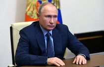 Russian President Vladimir Putin listens to Russian gas monopoly Gazprom Head, Alexei Miller via a video conference.